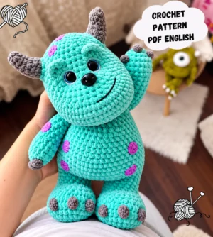 Crochet monster pattern PDF showing a turquoise baby ogre amigurumi with gray horns, lilac spots and raised arms