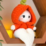 Ghost crochet pattern featuring Momo Ghost with an orange pumpkin hood