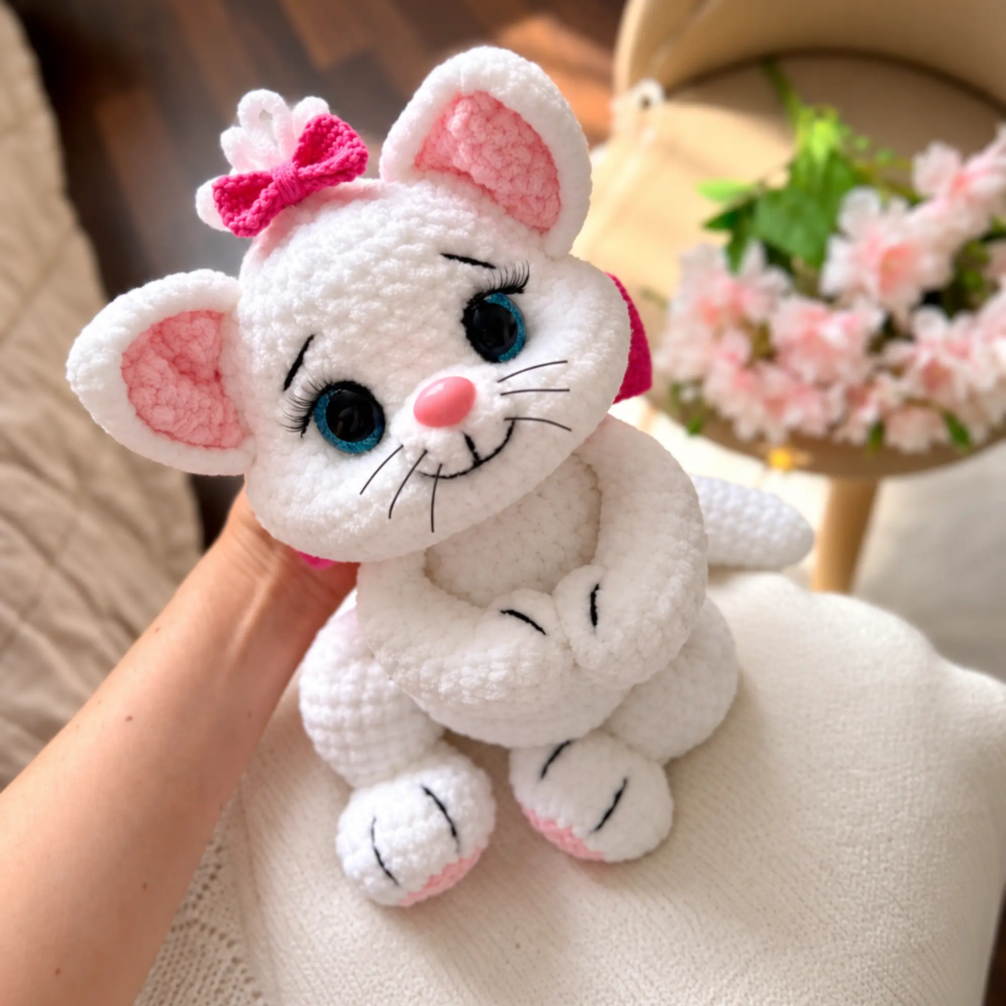 Crochet Cat Pattern PDF – Kitty With a Bow Amigurumi Crochet cat pattern featuring a white plush kitty with blue eyes, pink ears and bright pink bows